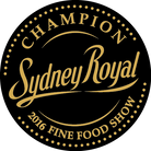 Gold circular emblem featuring "Champion Sydney Royal 2016 Fine Food Show" text.